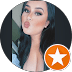 A woman with dark hair blowing a kiss.