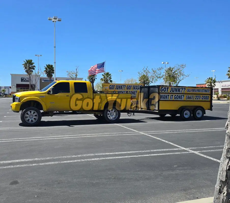 Lancaster junk removal yellow truck in the parking lot.