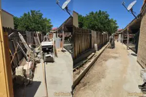 Side yard junk removal in Palmdale, CA. before and after cleanup showing removed debris, scrap wood, and old fencing materials.