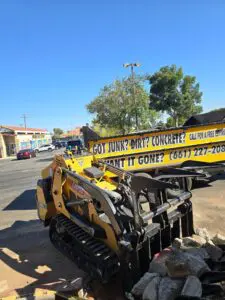 Bobcat-style mini loader used for dirt and concrete removal in Lancaster.