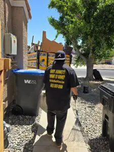 Worker hauling large items into a junk removal trailer in Quartz Hill, CA.