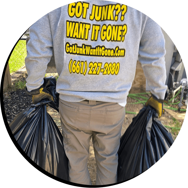 Affordable Hauling team member removing trash bags during a junk cleanup job in Palmdale California, serving Lancaster and the Antelope Valley.