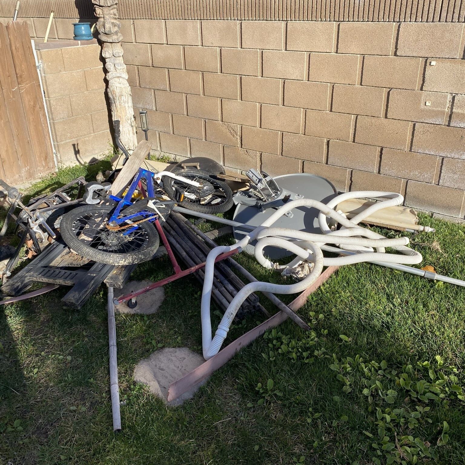 junk removal lancaster ca backyard debris pile before cleanup